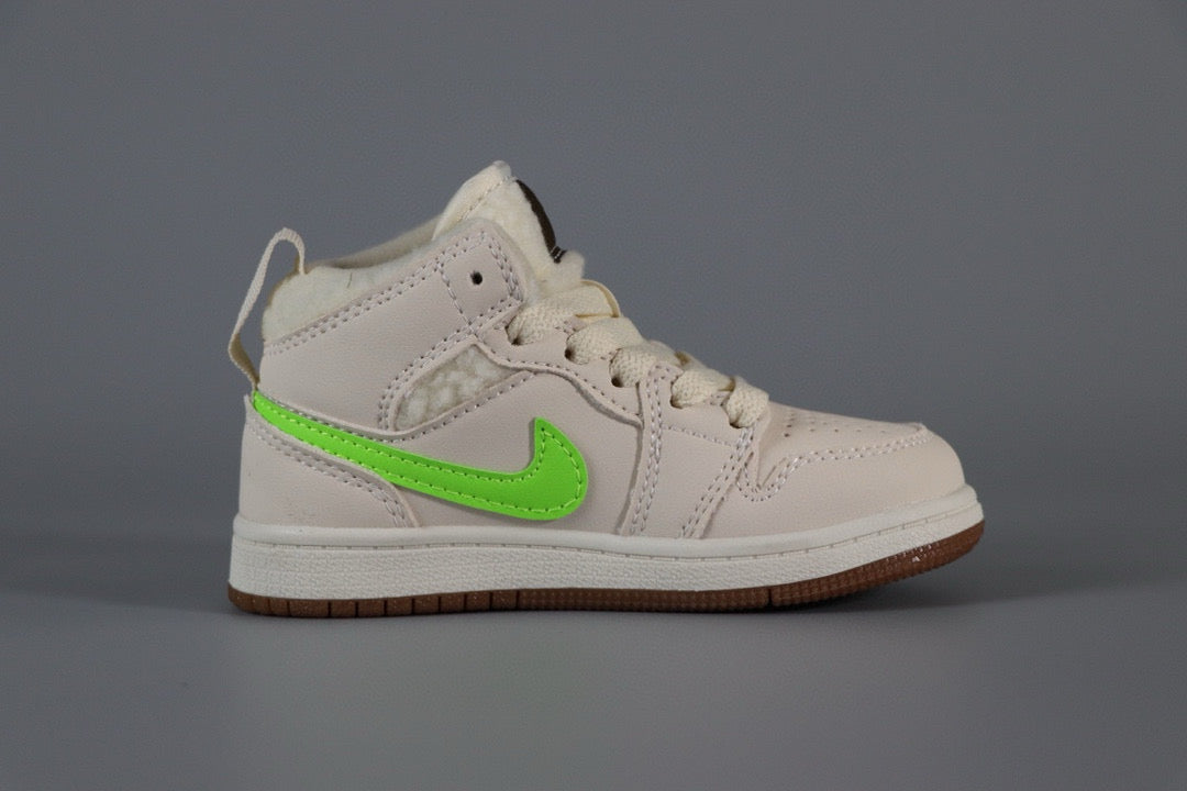 a pair of white and green shoes on a gray surface