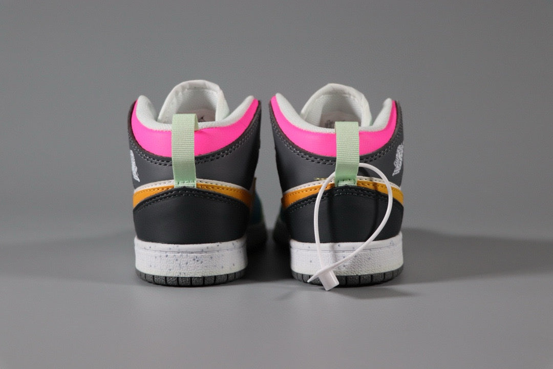 a pair of black and pink sneakers on a gray surface