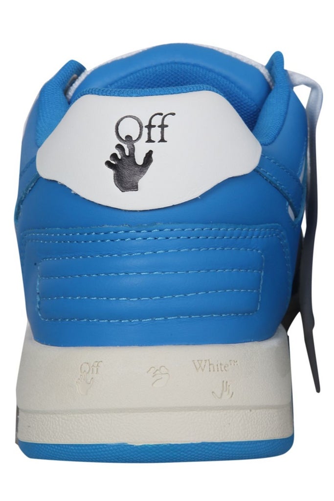 a blue and white shoe with a hand on it