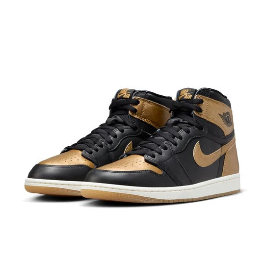 a pair of black and gold sneakers on a white background