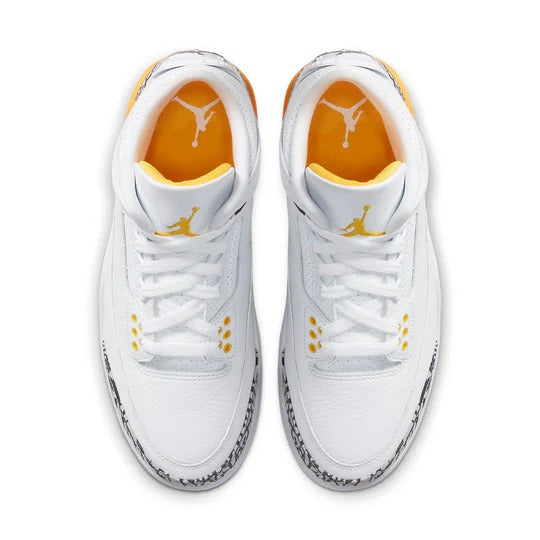 a pair of white and yellow sneakers on a white background