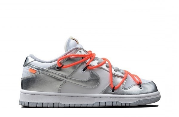 a pair of silver sneakers with orange laces